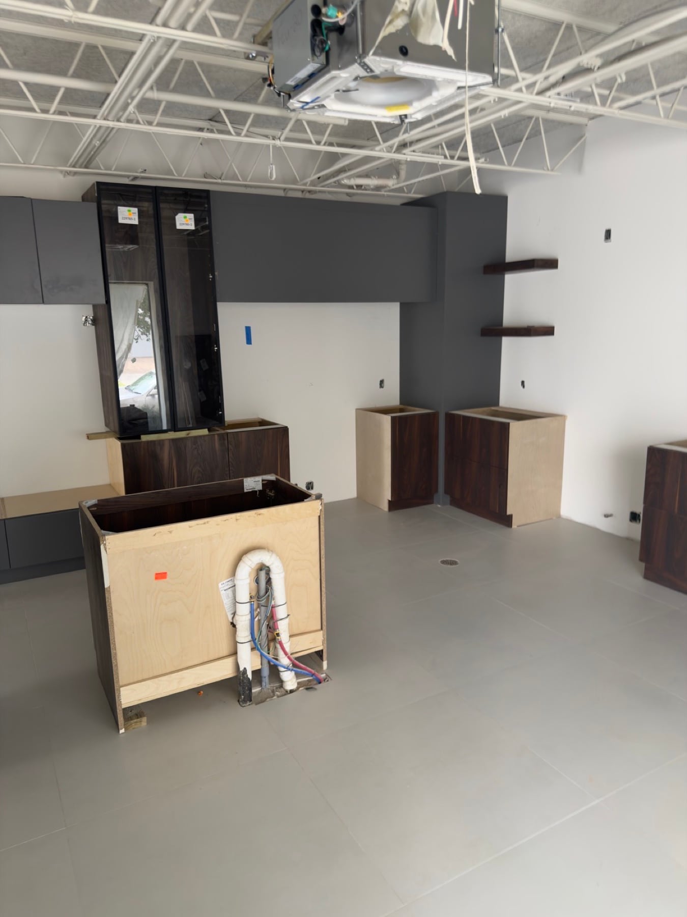 Walnut and charcoal millwork installation in progress.