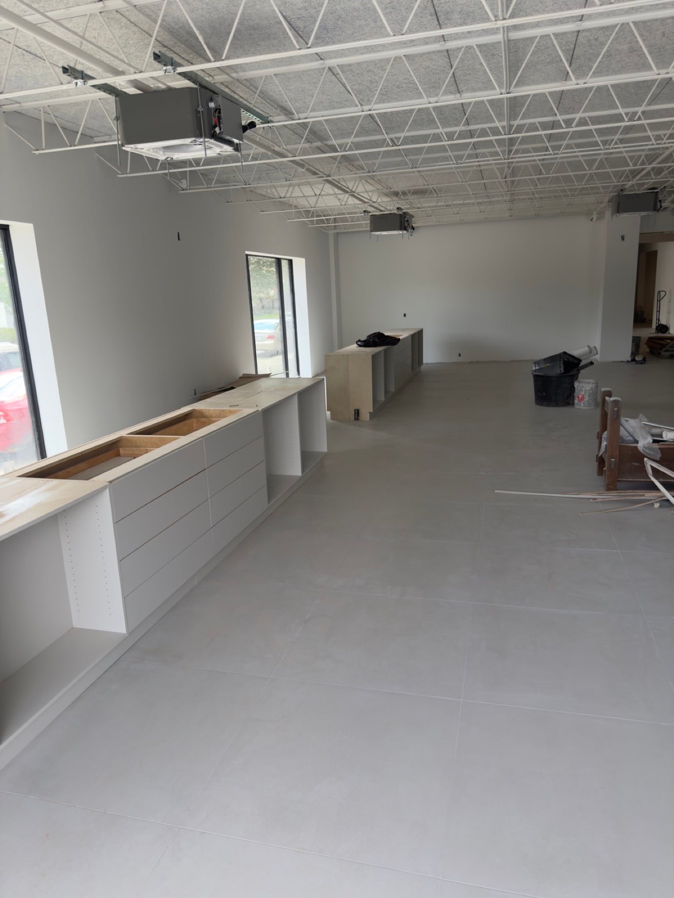 Long cabinetry installation in a commercial interior under construction.
